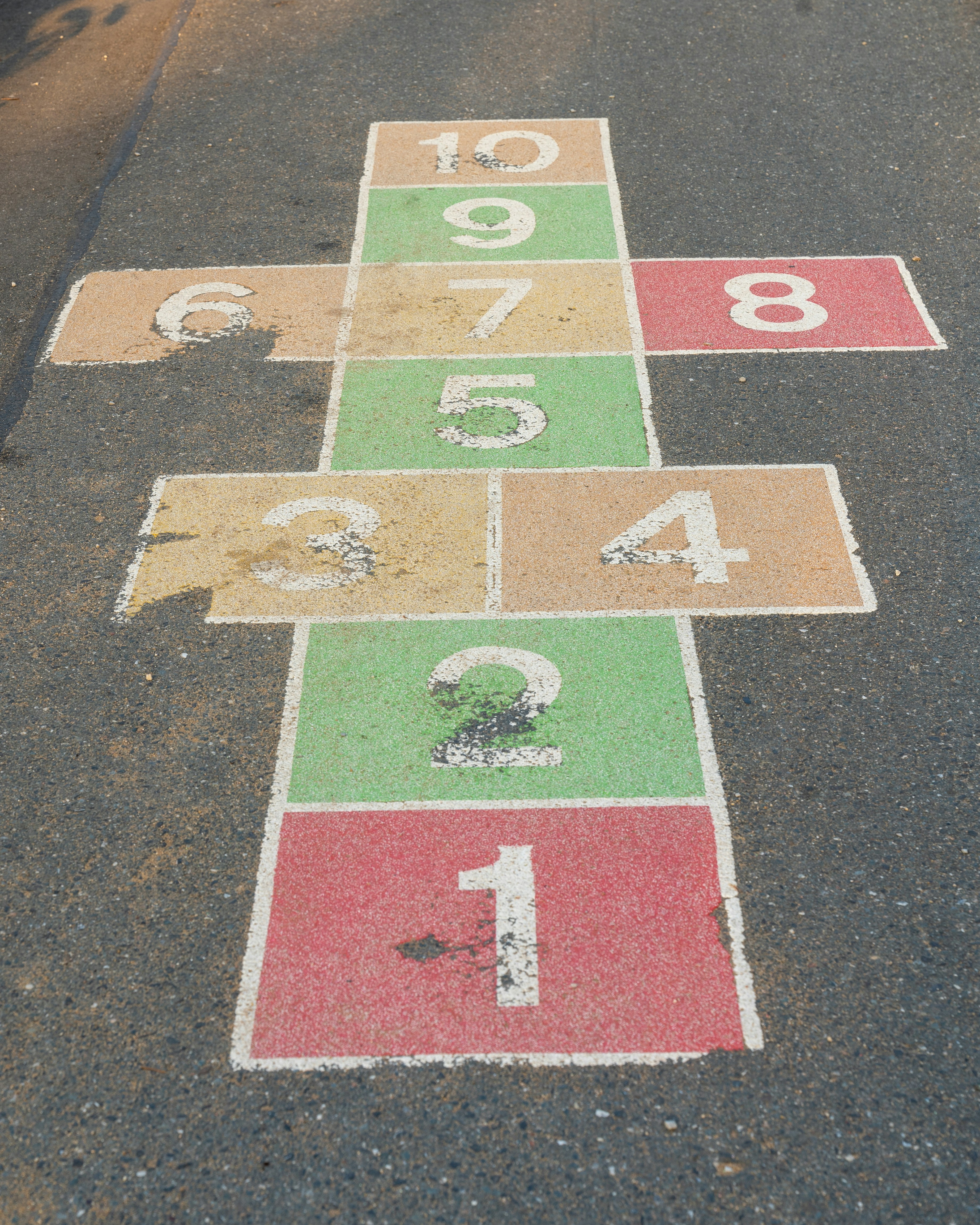 Hüpfspiel mit bunten, nummerierten Feldern von 1 bis 10.